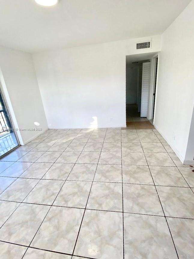 850 Southwest 74th Terrace, Unit 2 Pompano Beach, FL 33068 - Photo 5 of 11 a view of an empty room and window