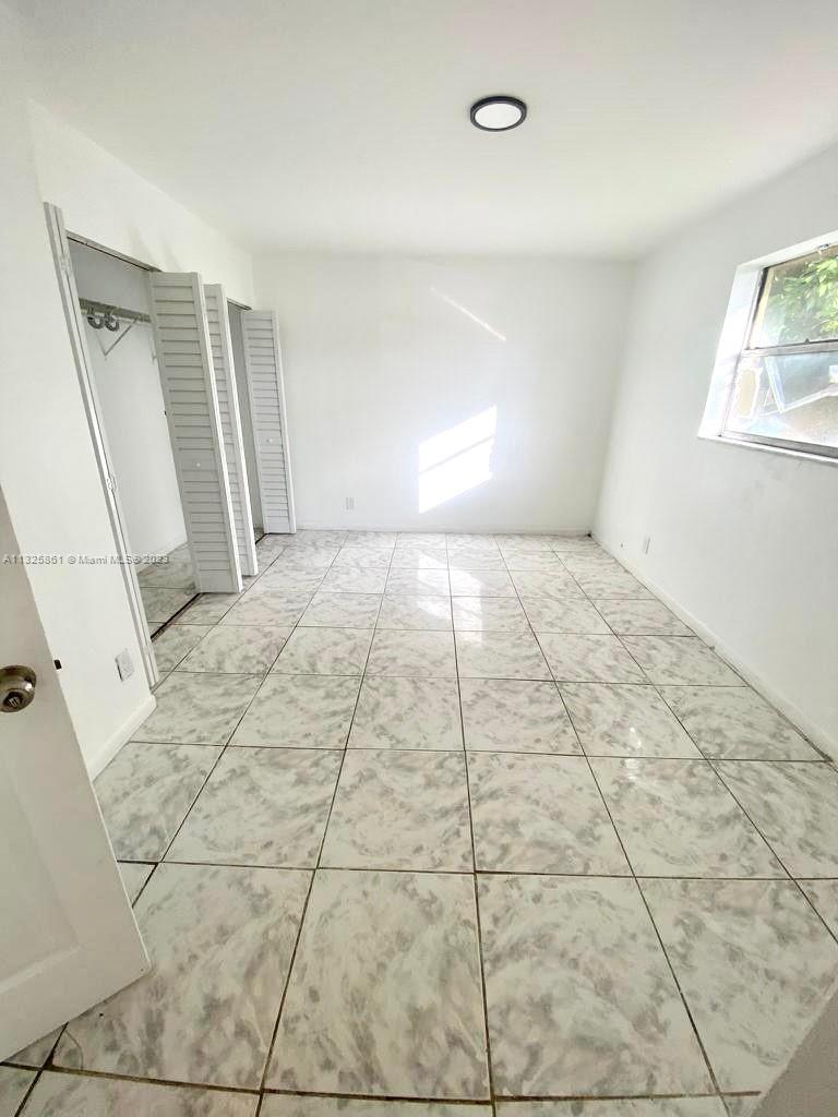 850 Southwest 74th Terrace, Unit 2 Pompano Beach, FL 33068 - Photo 6 of 11 a view of an empty room and a window