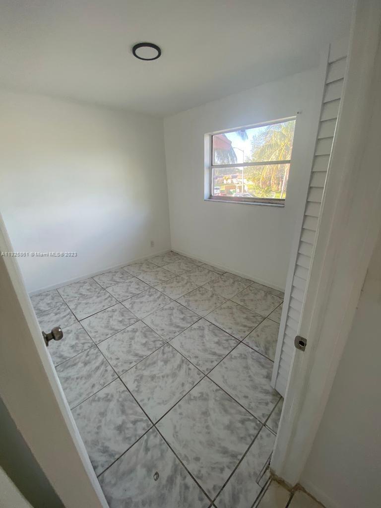 850 Southwest 74th Terrace, Unit 2 Pompano Beach, FL 33068 - Photo 8 of 11 a view of an empty room and window