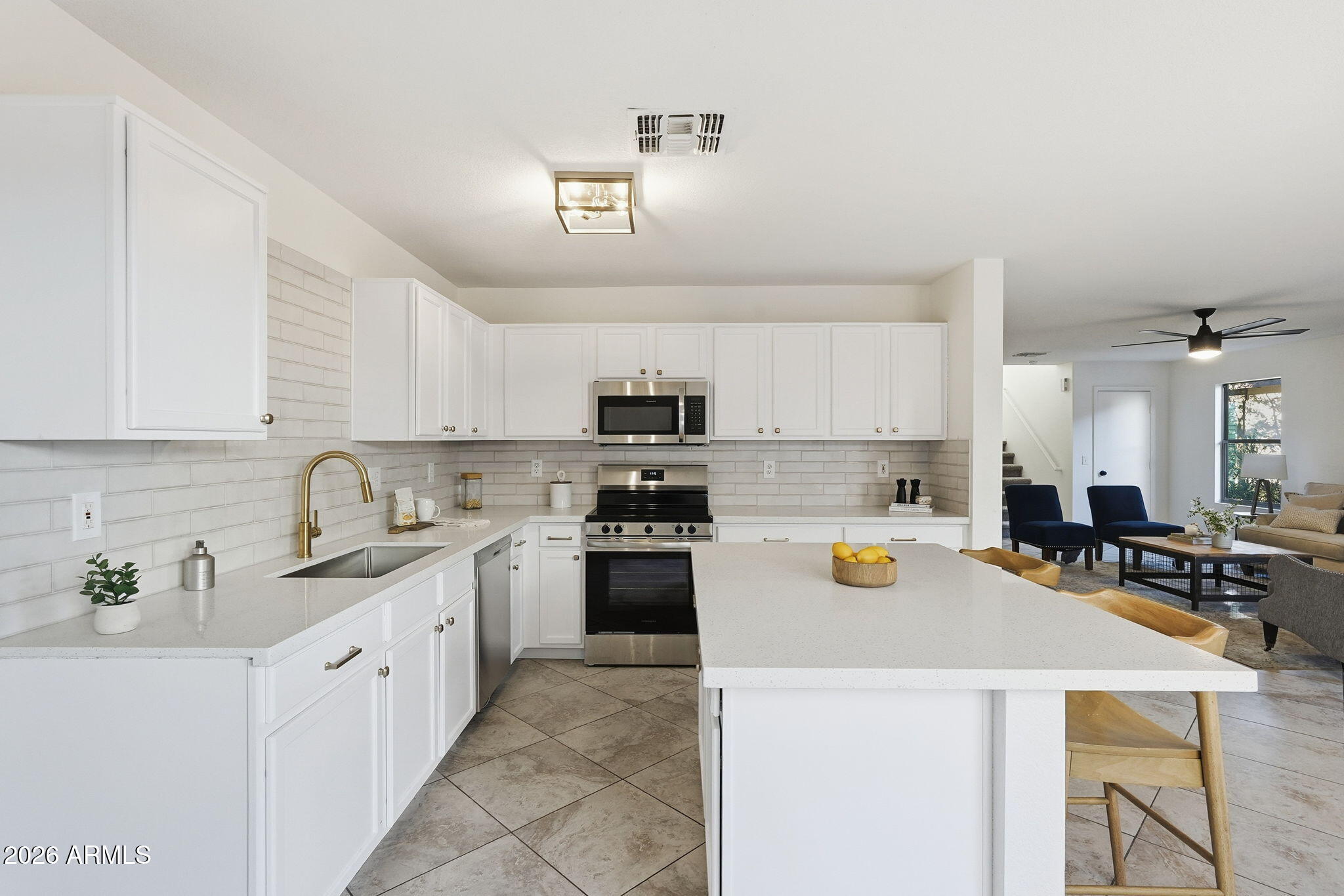 a kitchen with a white cabinets and appliances
