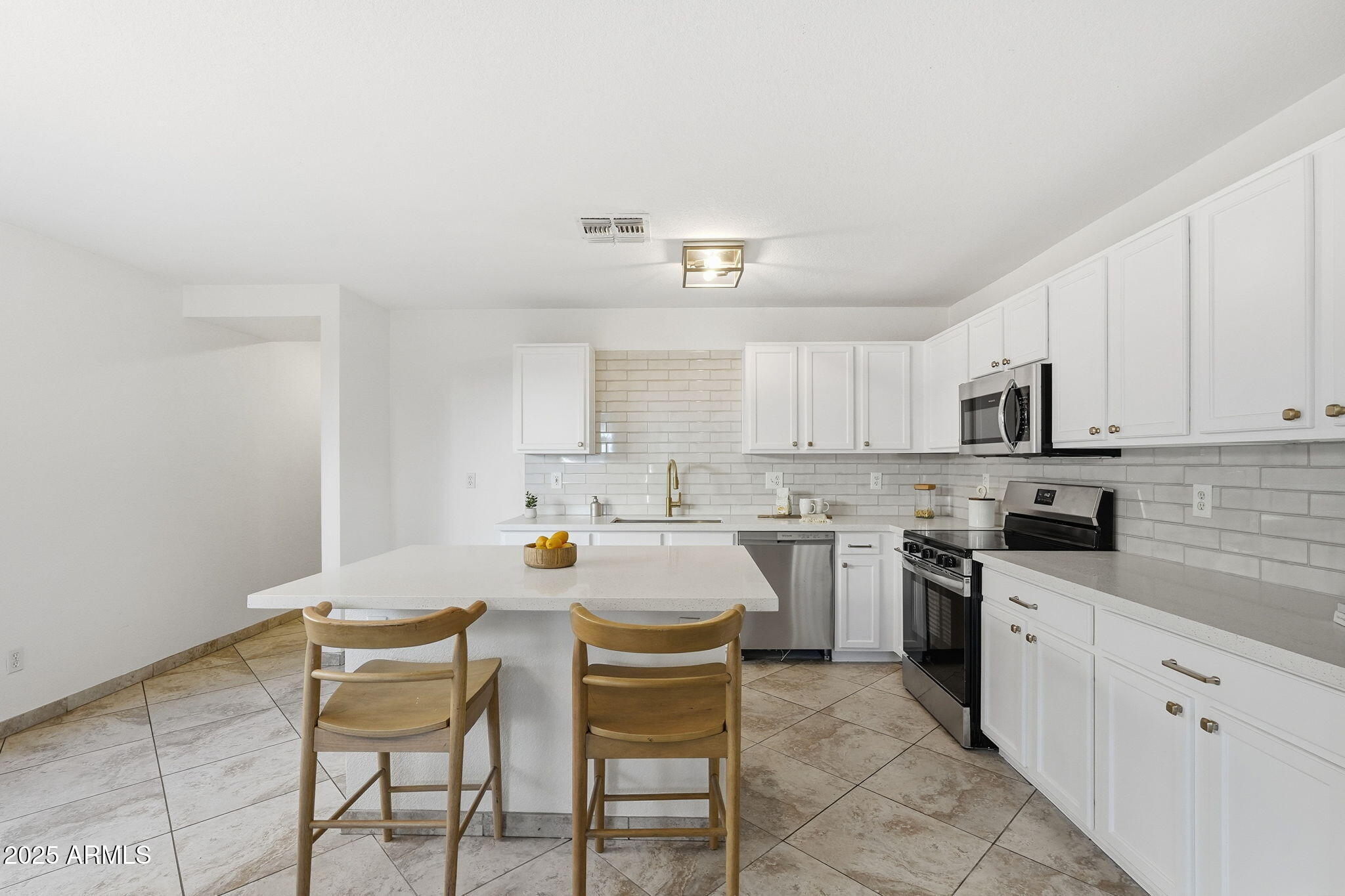 3287 South Bowman Road Apache Junction, AZ 85119 - Photo 10 of 40 a kitchen with a cabinets and chairs