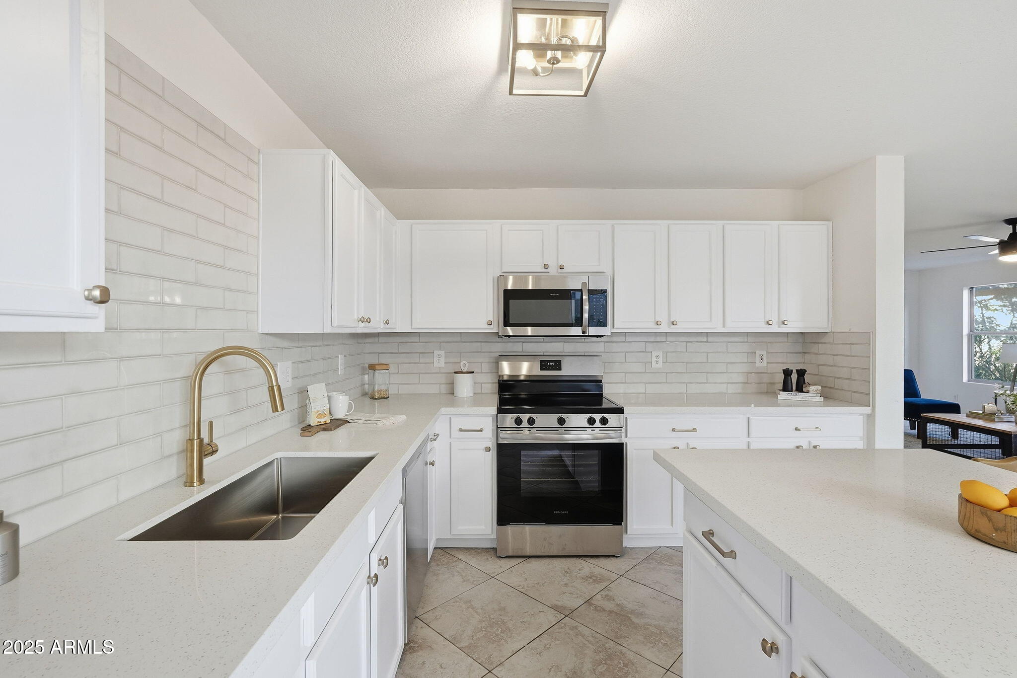3287 South Bowman Road Apache Junction, AZ 85119 - Photo 12 of 40 a kitchen with sink a stove and cabinets
