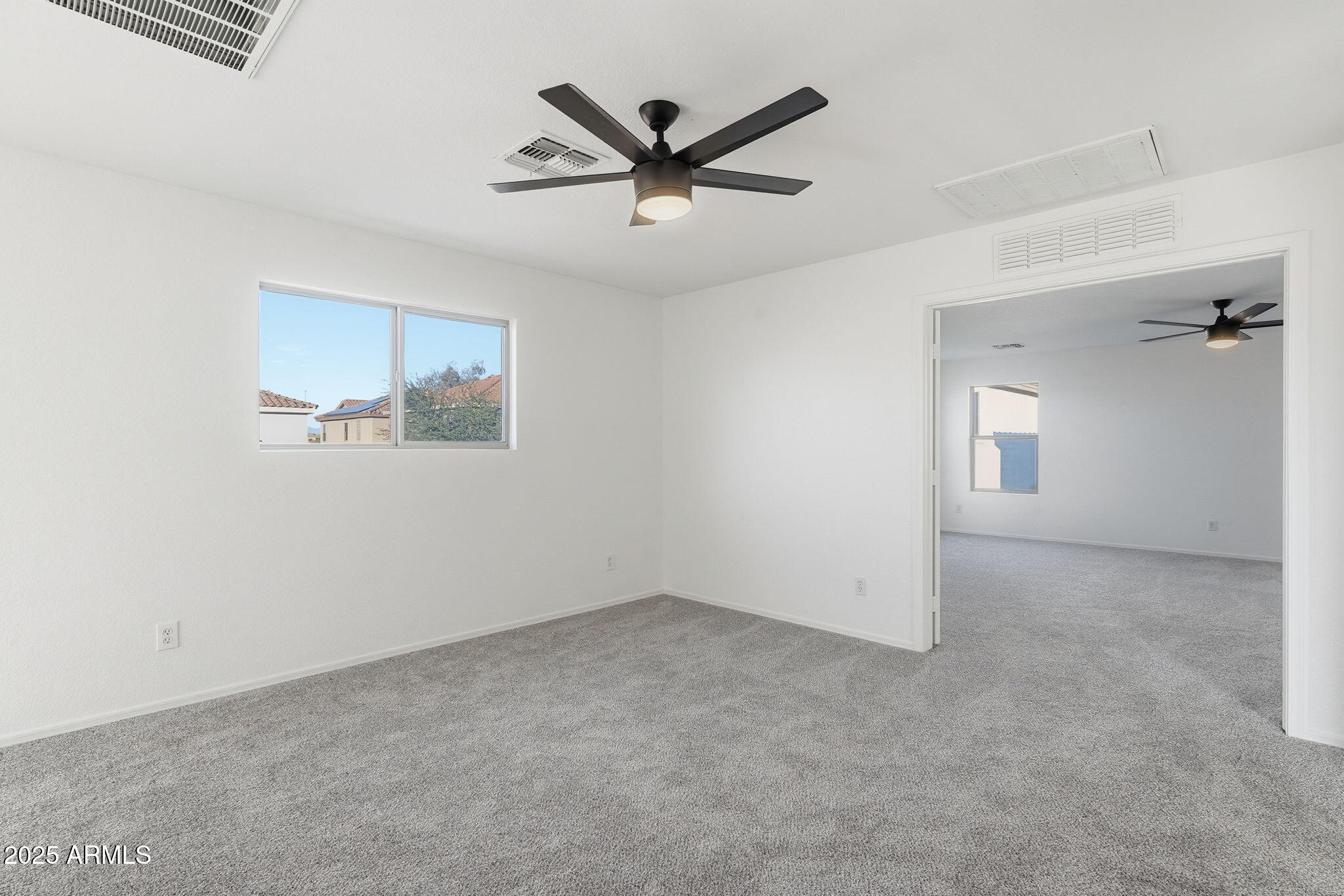 3287 South Bowman Road Apache Junction, AZ 85119 - Photo 18 of 40 an empty room with ceiling fan and windows
