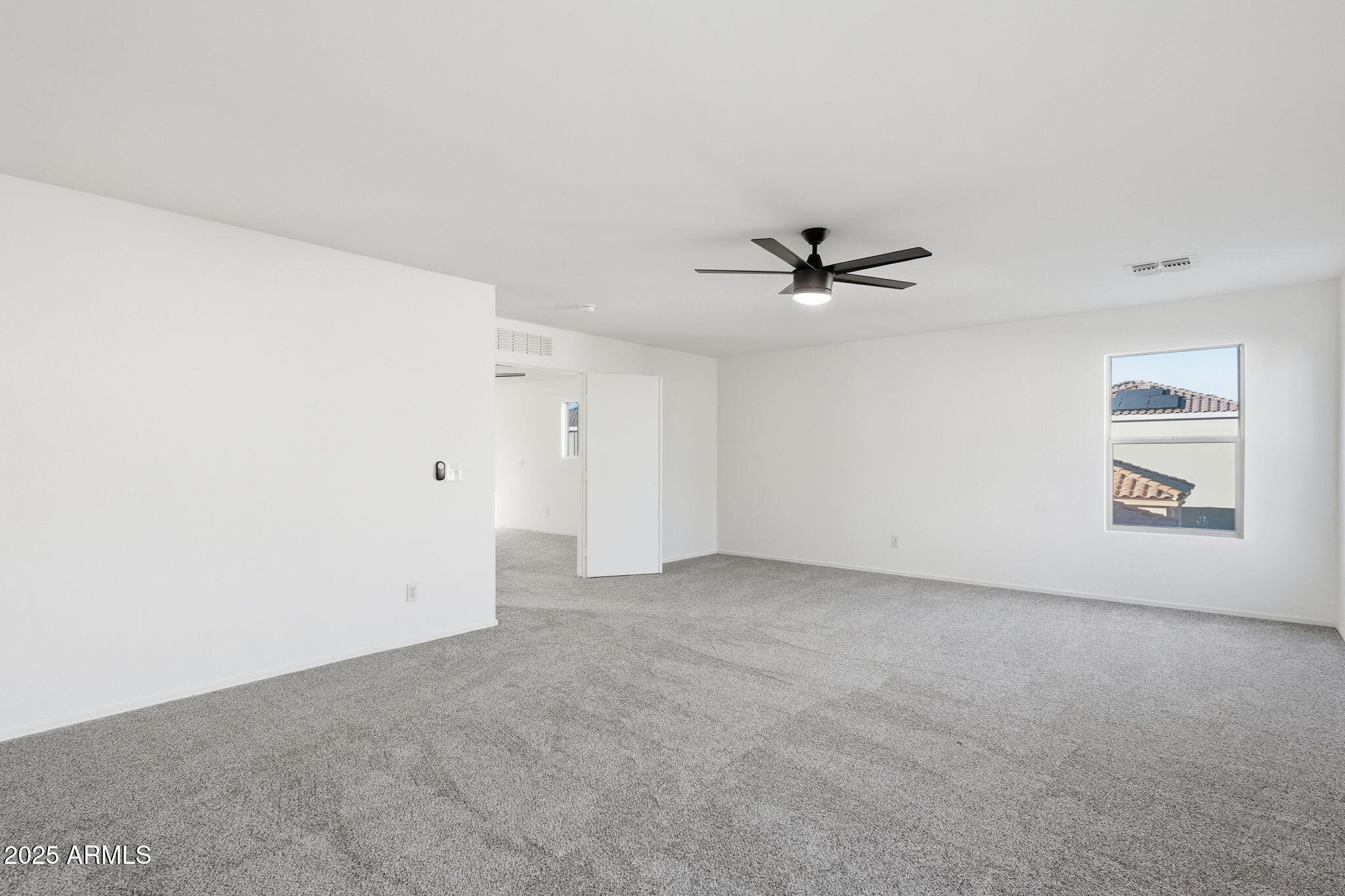 3287 South Bowman Road Apache Junction, AZ 85119 - Photo 22 of 40 an empty room with a ceiling fan and window
