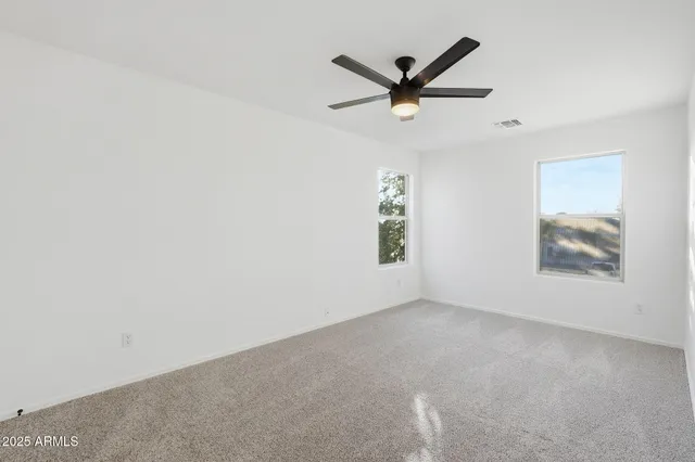 a view of walk in closet with empty racks
