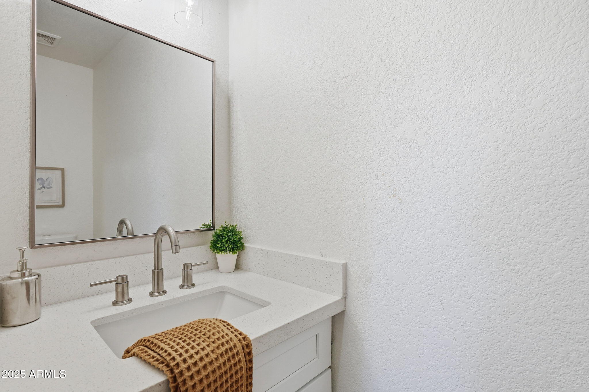 3287 South Bowman Road Apache Junction, AZ 85119 - Photo 31 of 38 a bathroom with a sink and a mirror