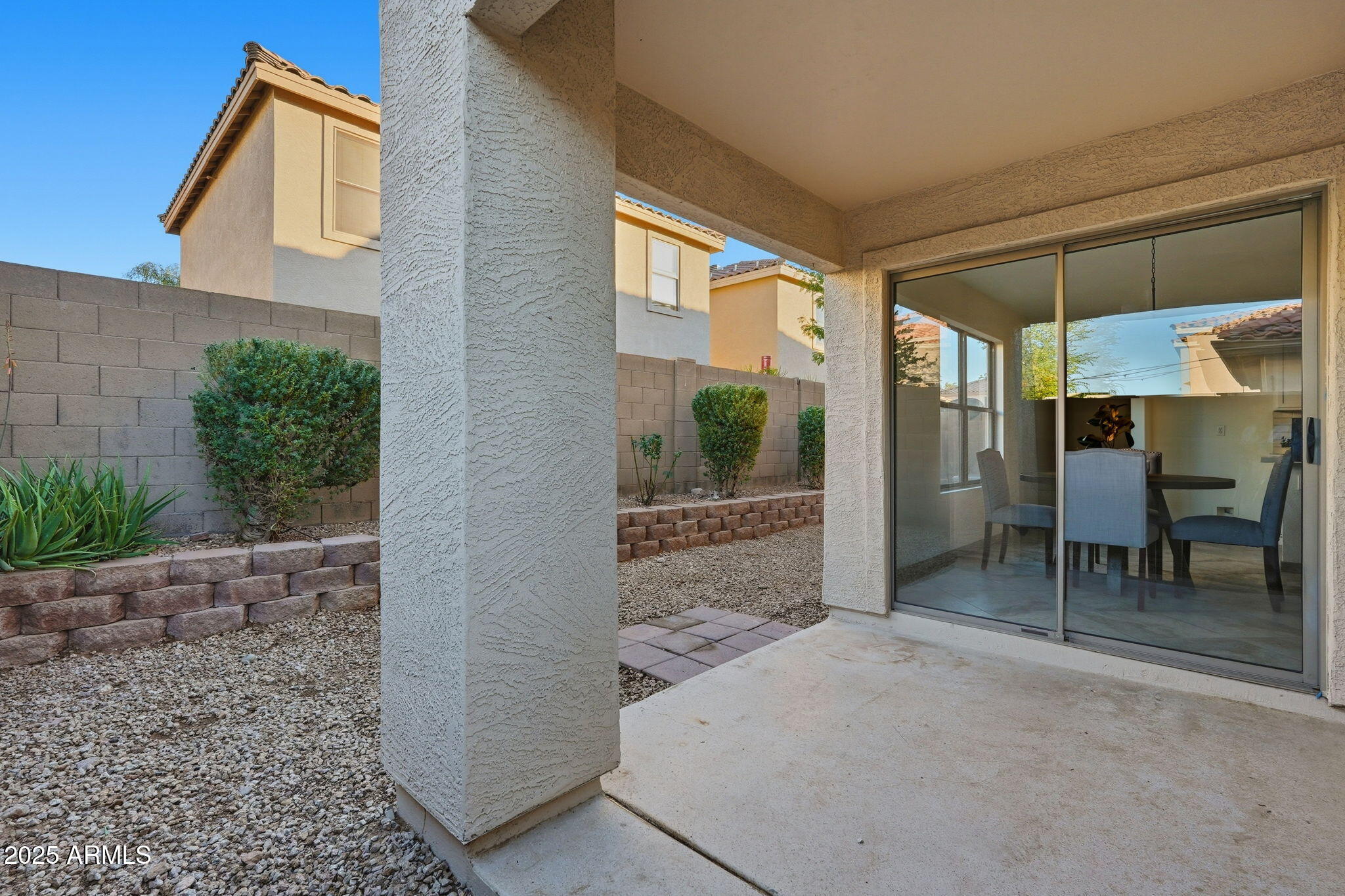 3287 South Bowman Road Apache Junction, AZ 85119 - Photo 35 of 40 a view of a patio with a table and chairs and potted plants