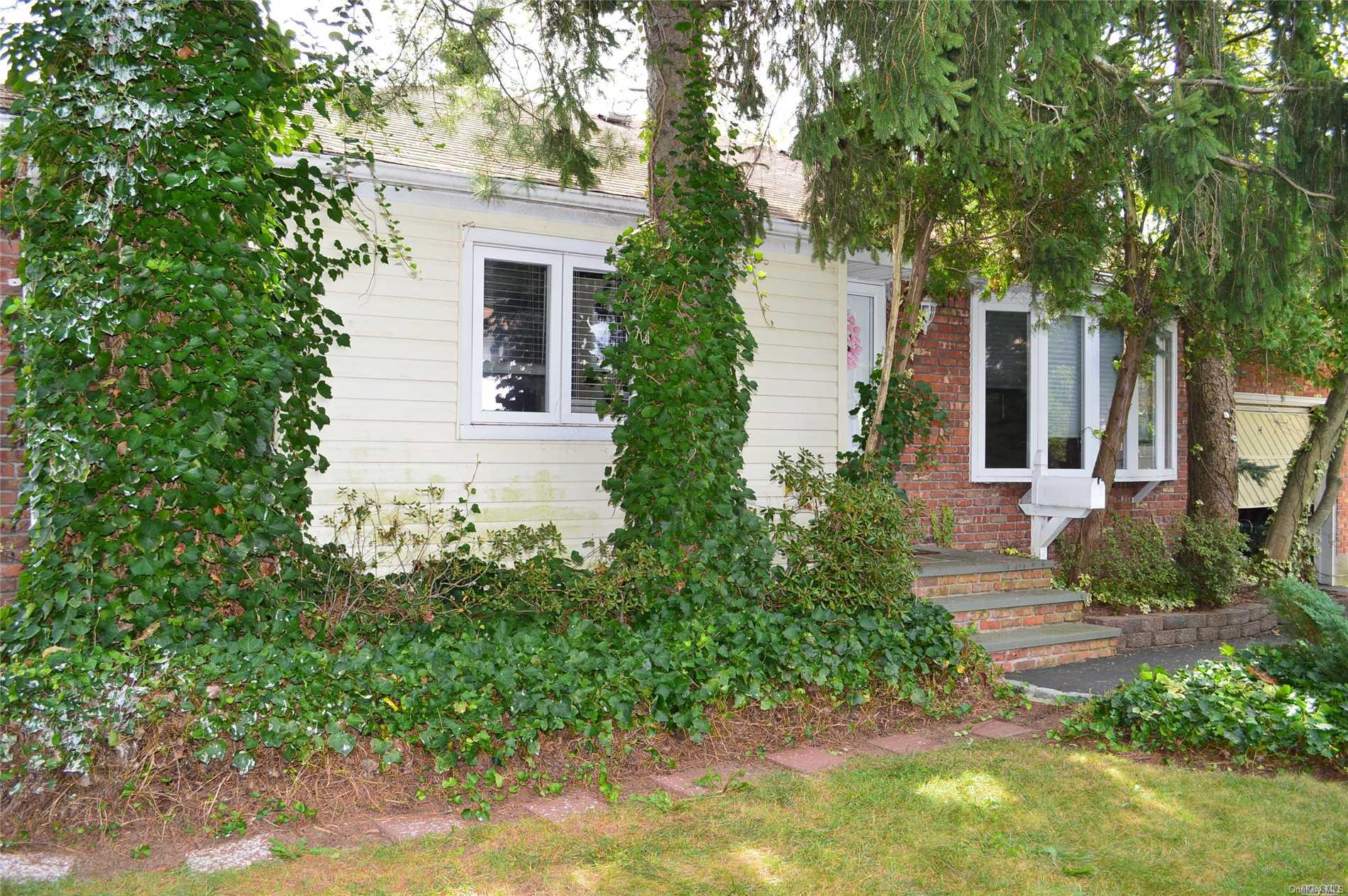 266 Central Park Road Plainview, NY 11803 - Photo 1 of 1 a house that has a tree in front of the house