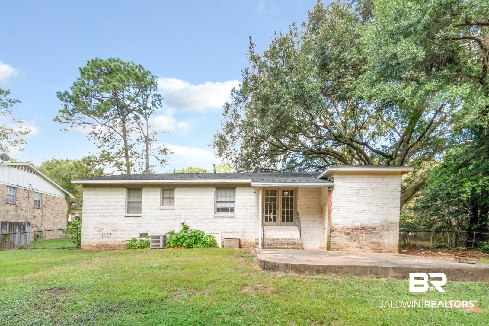 320 Vanderbilt Drive Mobile, AL 36608 - Photo 35 of 39 Back of house featuring a patio, a lawn, and central AC