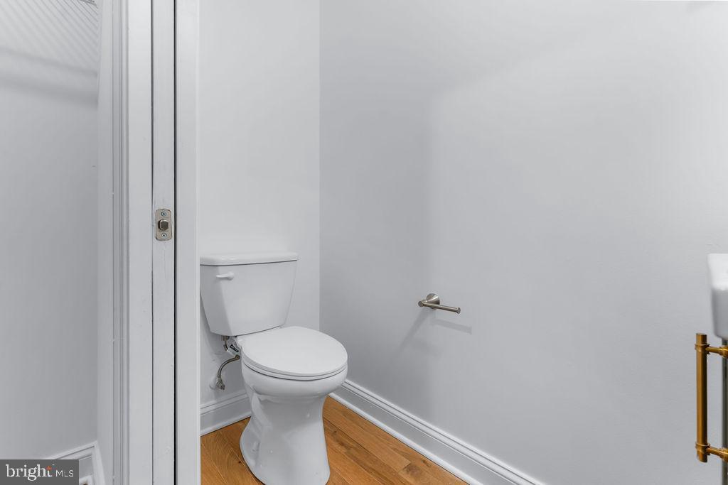 51 South Fulton Avenue Baltimore, MD 21223 - Photo 14 of 44 a white toilet sitting next to a shower