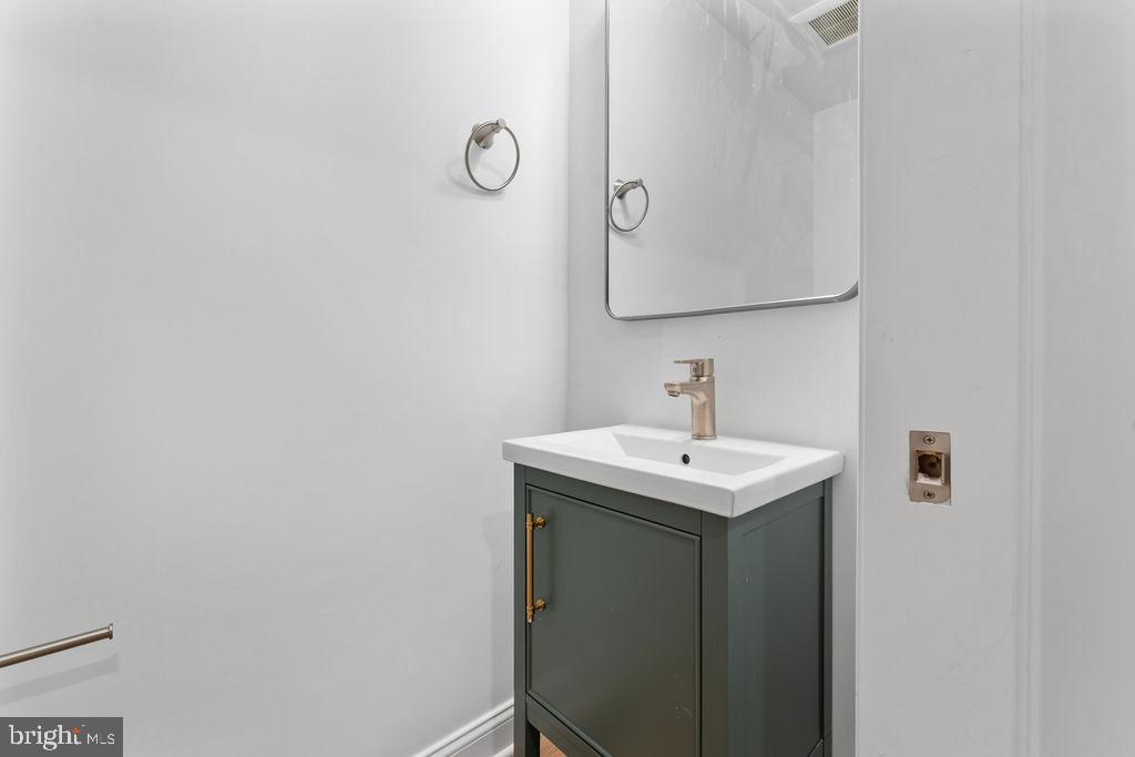51 South Fulton Avenue Baltimore, MD 21223 - Photo 15 of 44 a bathroom with a sink and a mirror