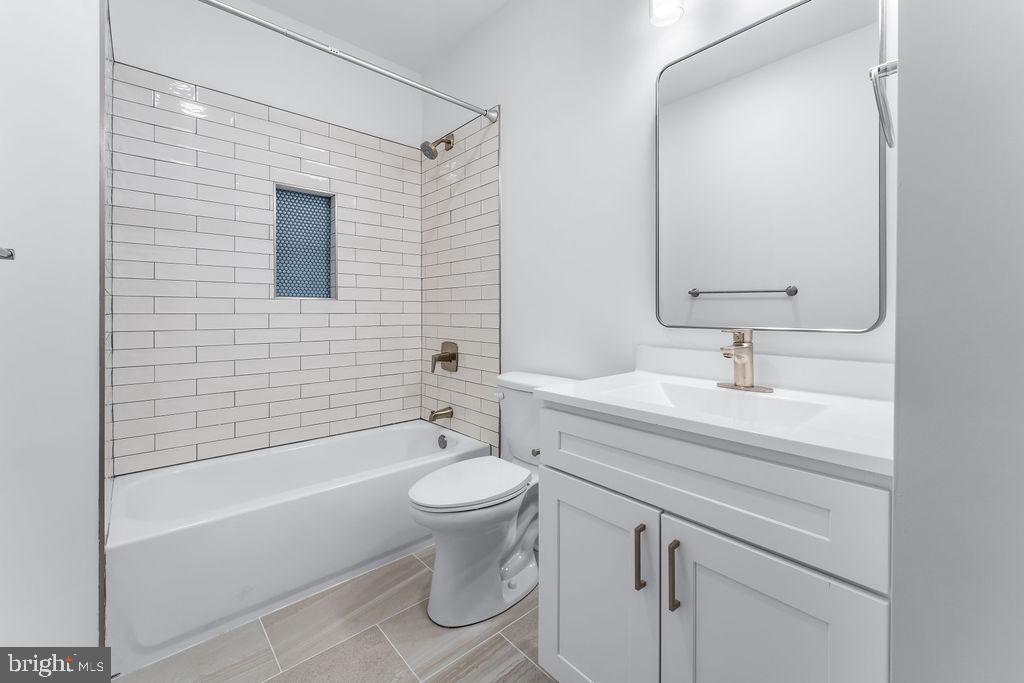 51 South Fulton Avenue Baltimore, MD 21223 - Photo 19 of 44 a bathroom with a sink toilet a bathtub and shower