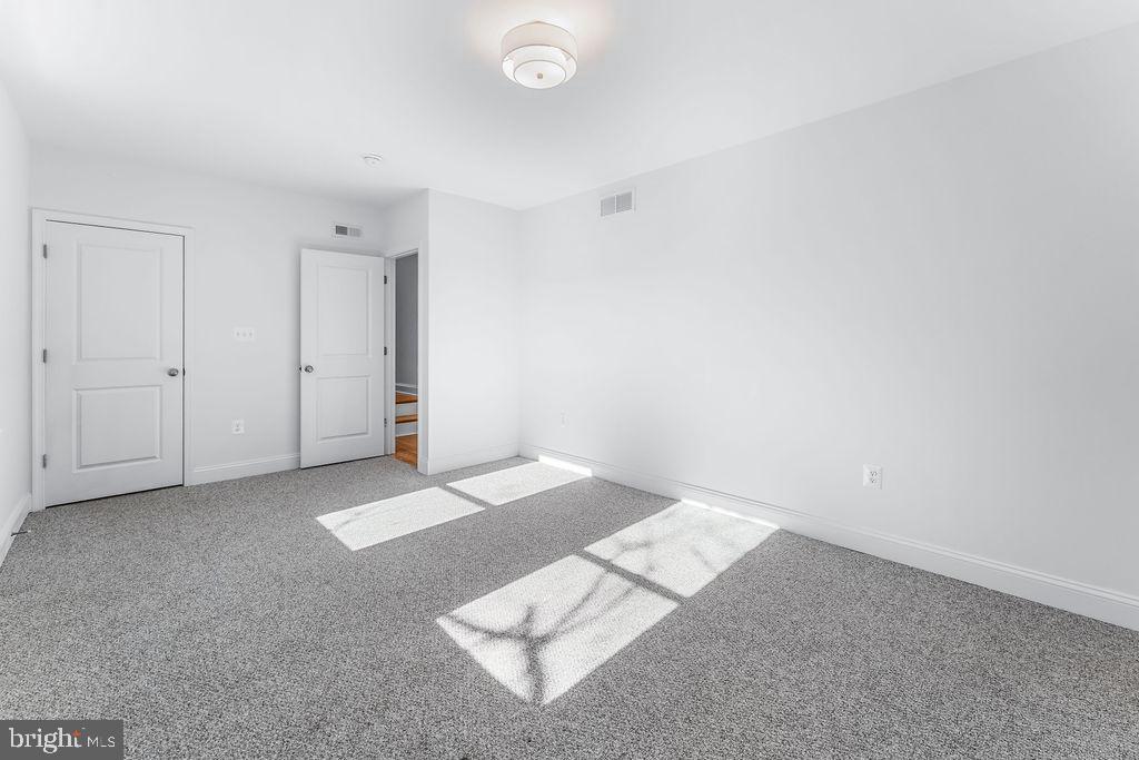 51 South Fulton Avenue Baltimore, MD 21223 - Photo 21 of 44 an empty room with windows