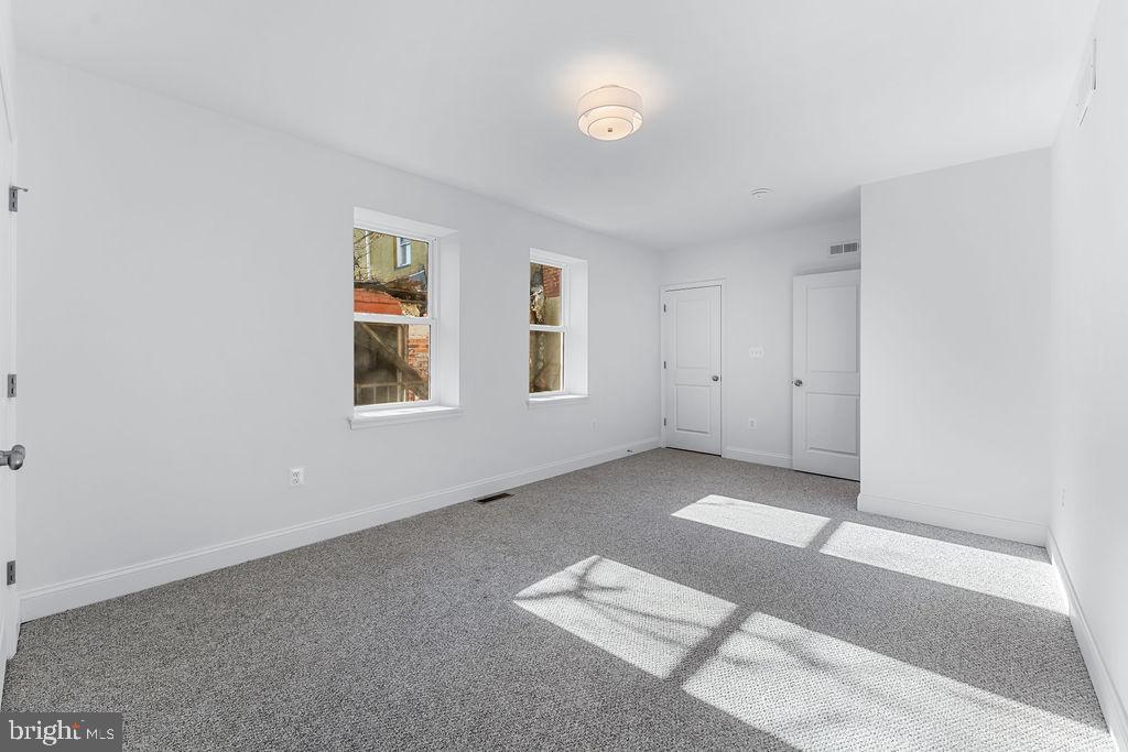 51 South Fulton Avenue Baltimore, MD 21223 - Photo 22 of 44 an empty room with windows