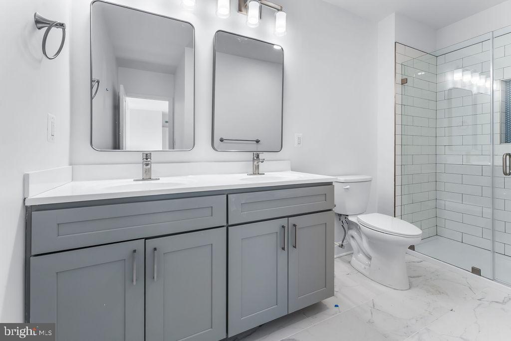 51 South Fulton Avenue Baltimore, MD 21223 - Photo 23 of 44 a bathroom with a sink toilet and shower