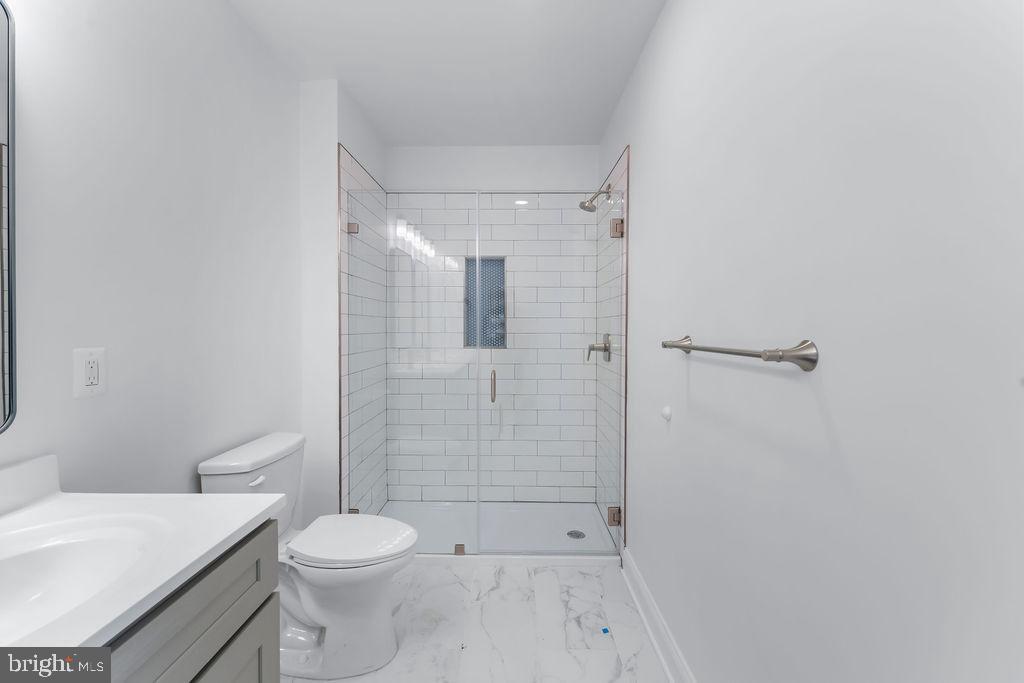 51 South Fulton Avenue Baltimore, MD 21223 - Photo 24 of 44 a bathroom with a shower a toilet and sink