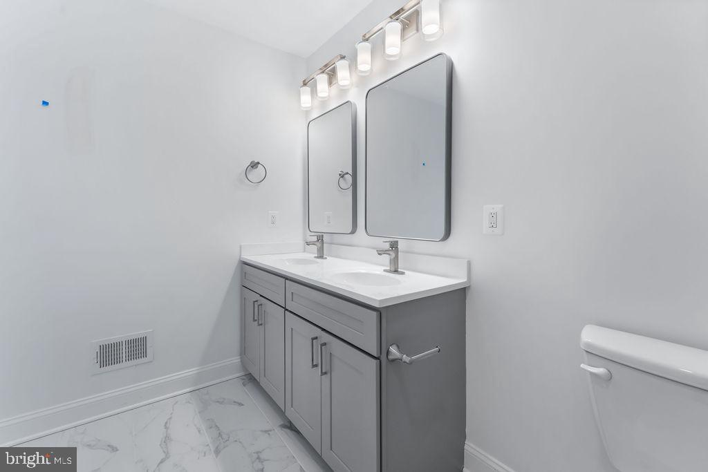 51 South Fulton Avenue Baltimore, MD 21223 - Photo 25 of 44 a bathroom with a sink and a mirror