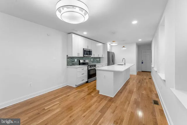 a view of kitchen with sink microwave and stove