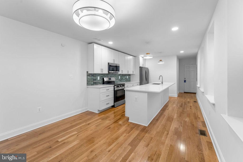51 South Fulton Avenue Baltimore, MD 21223 - Photo 7 of 44 a view of kitchen with sink microwave and stove
