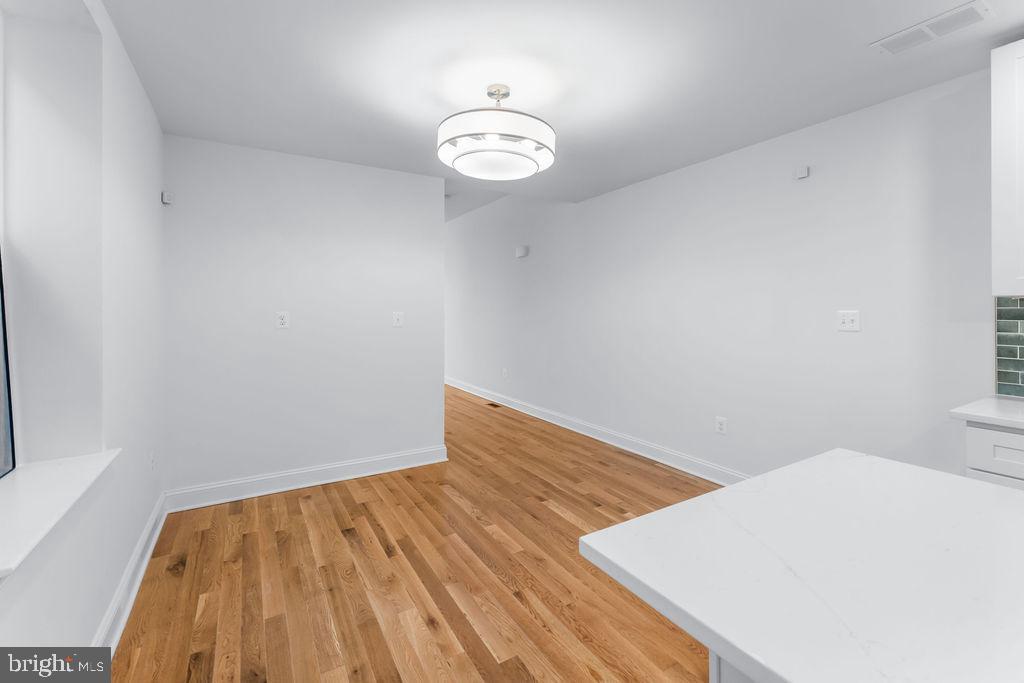 51 South Fulton Avenue Baltimore, MD 21223 - Photo 8 of 44 a view of empty room with wooden floor