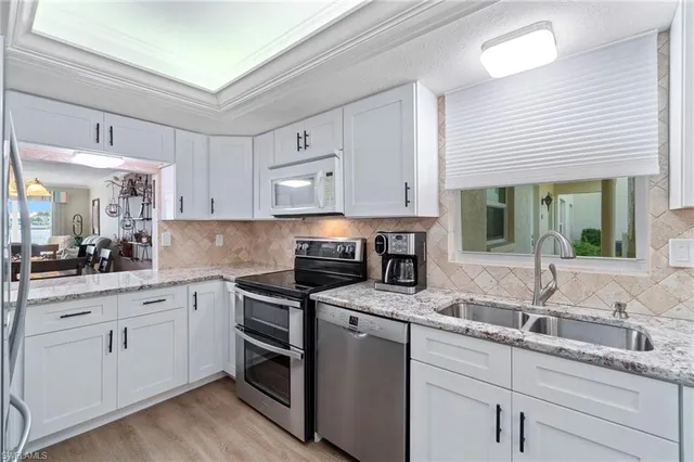 a kitchen with a sink stove and cabinets