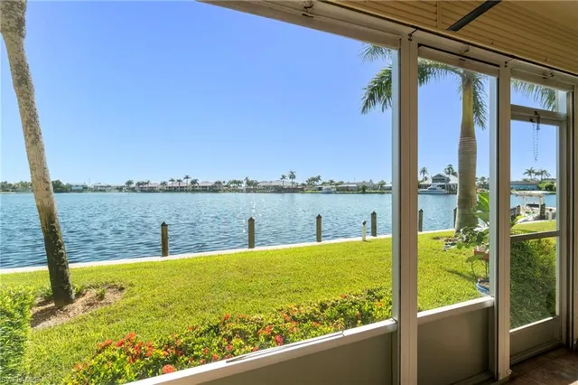 a view of roof deck with two chairs and a potted plant