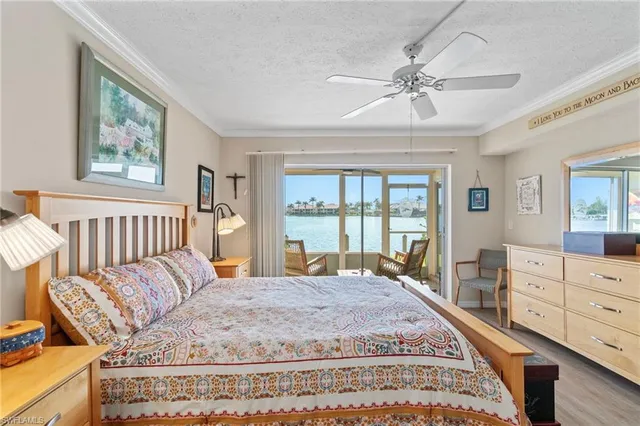 a spacious bedroom with a large bed and a chandelier