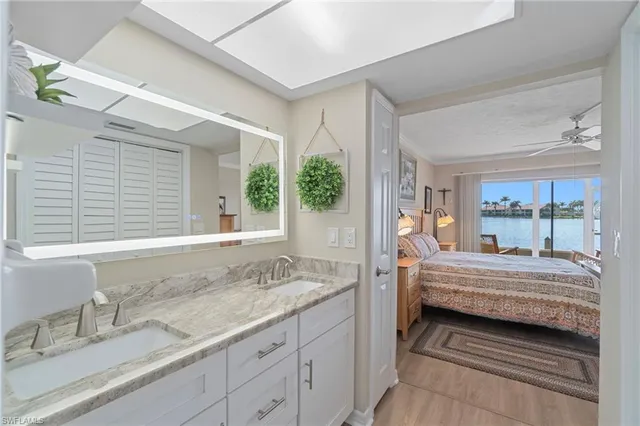 a spacious bathroom with a granite countertop tub sink and mirror