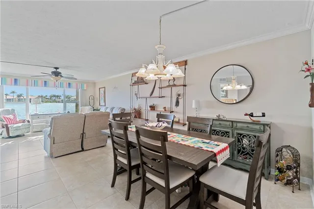 a view of a dining room with furniture and chandelier