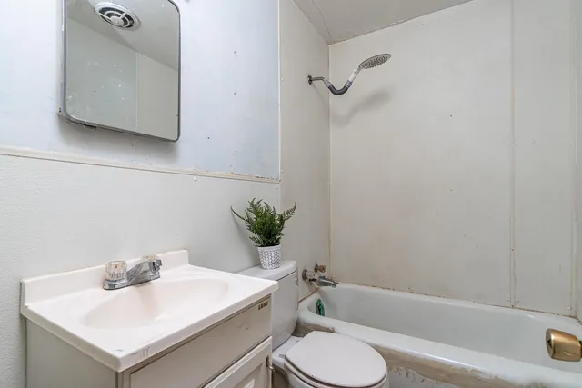 an empty room with closet and a chandelier fan