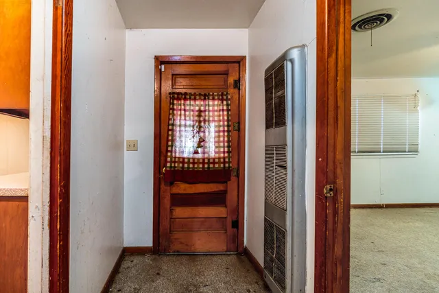 a view of a house with large windows and a small yard
