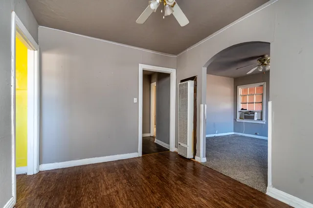 a kitchen with white cabinets and a window