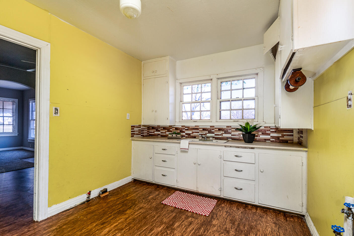 210 North Floyd Avenue Tulia, TX 79088 - Photo 27 of 35 a room with window wooden floor and glass door