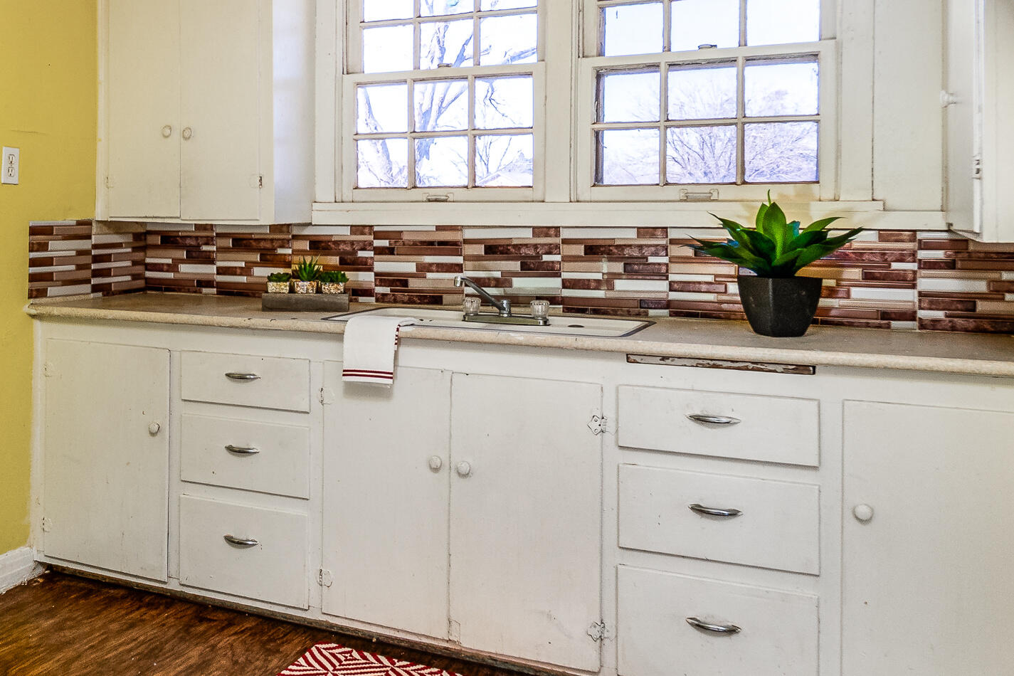 210 North Floyd Avenue Tulia, TX 79088 - Photo 28 of 35 a kitchen with white cabinets and a window