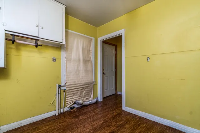 wooden floor with white walls and windows