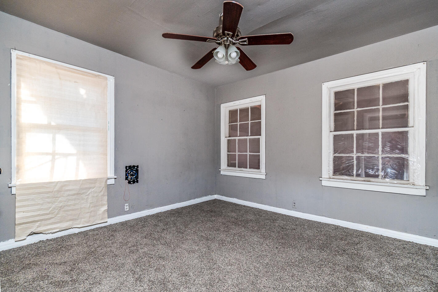 210 North Floyd Avenue Tulia, TX 79088 - Photo 32 of 35 an empty room with windows and fan
