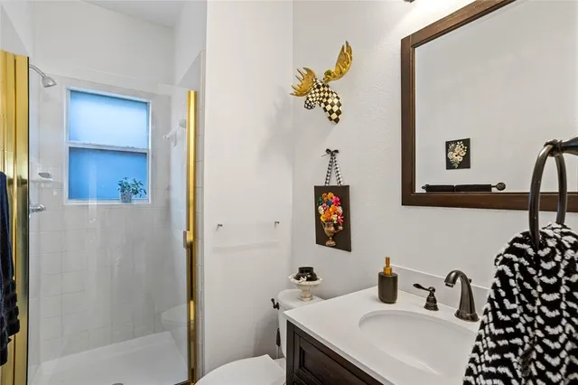 a bathroom with a sink toilet and shower