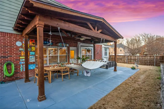 a view of a patio with table and chairs and potted plants