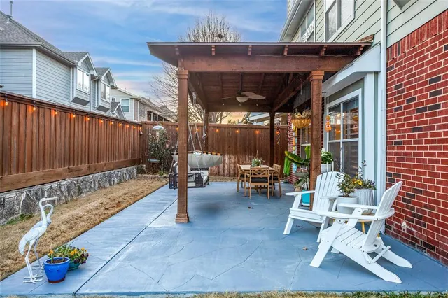 a view of a patio with a dining table and chairs with wooden floor