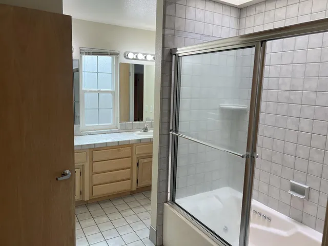 a bathroom with a shower and a sink