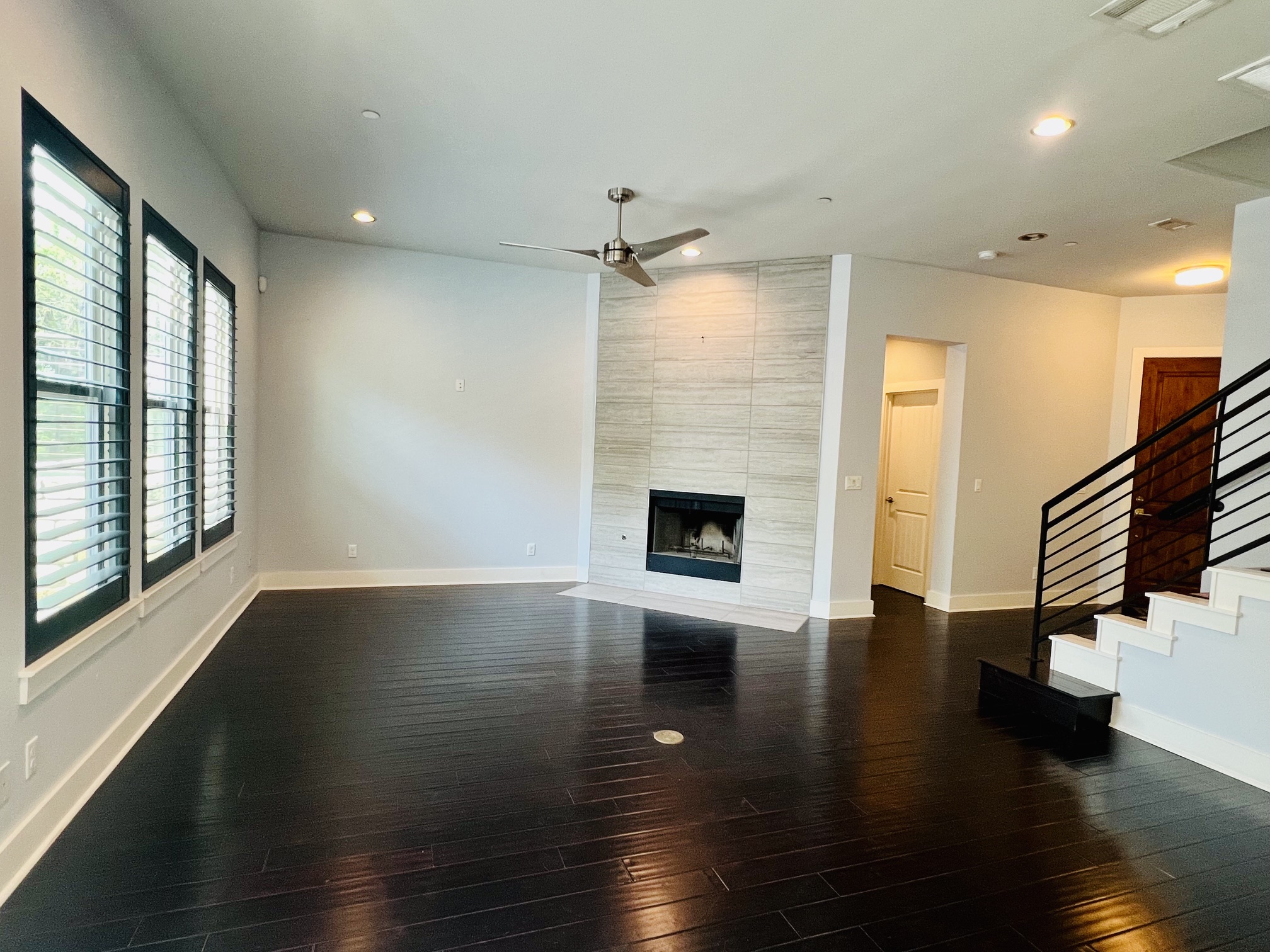 8110 Southeast Ranch Road 2222, Unit 98 Austin, TX 78730 - Photo 8 of 31 Dark wood flooring and a modern tiled fireplace create a striking focal point.