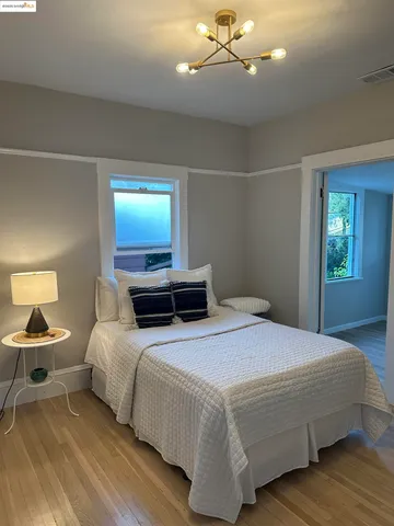 a bedroom with a bed and lamp