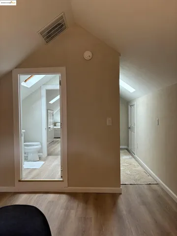 a bedroom with a bed and a potted plant