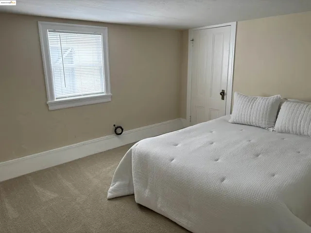 a kitchen with granite countertop white cabinets and refrigerator