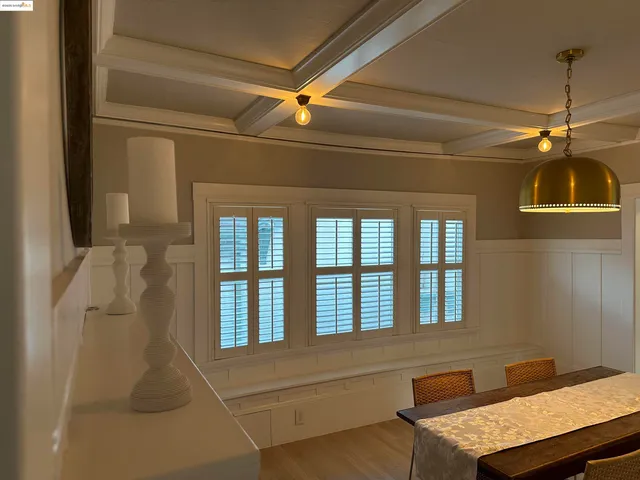 a kitchen with a stove a sink a dining table and chairs