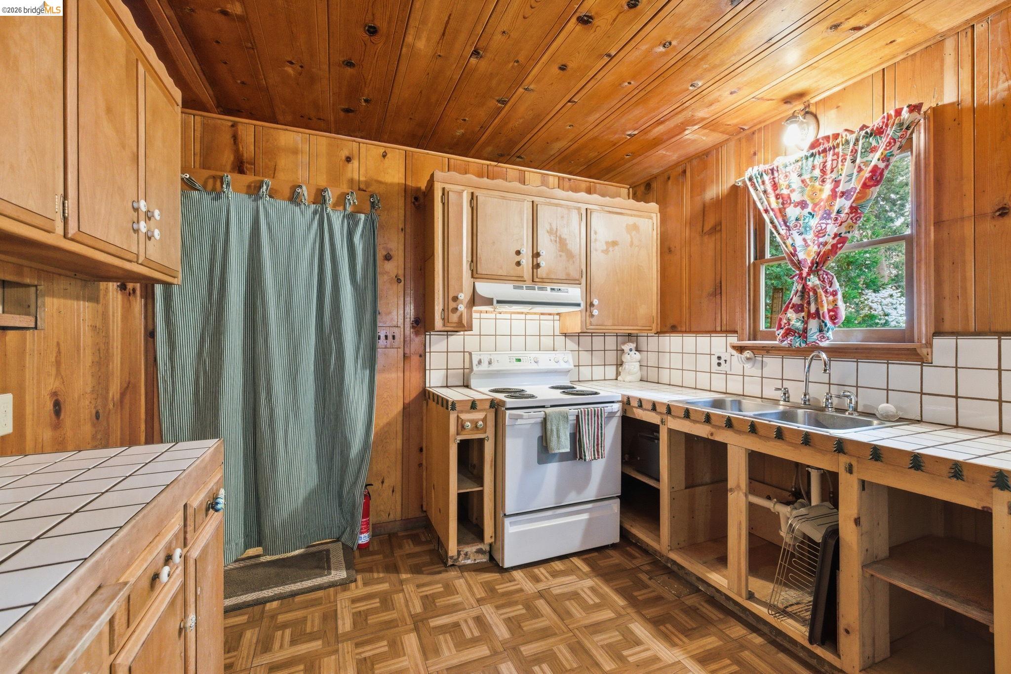 24249 Sugarpine Road Mi Wuk Village, CA 95383 - Photo 4 of 18 a kitchen with stainless steel appliances granite countertop a stove a sink and a refrigerator