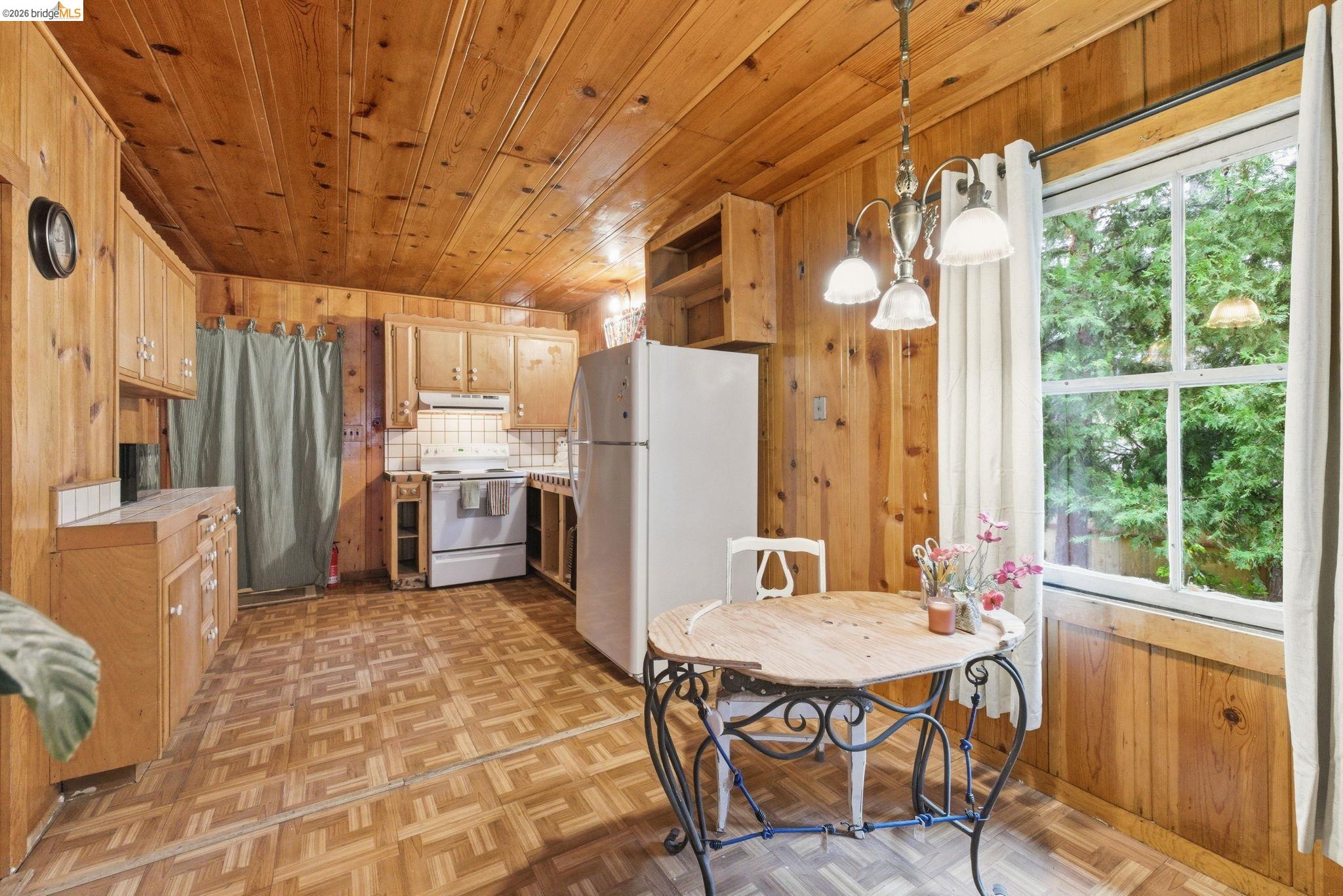 24249 Sugarpine Road Mi Wuk Village, CA 95383 - Photo 5 of 18 a kitchen with a table chairs refrigerator and furniture