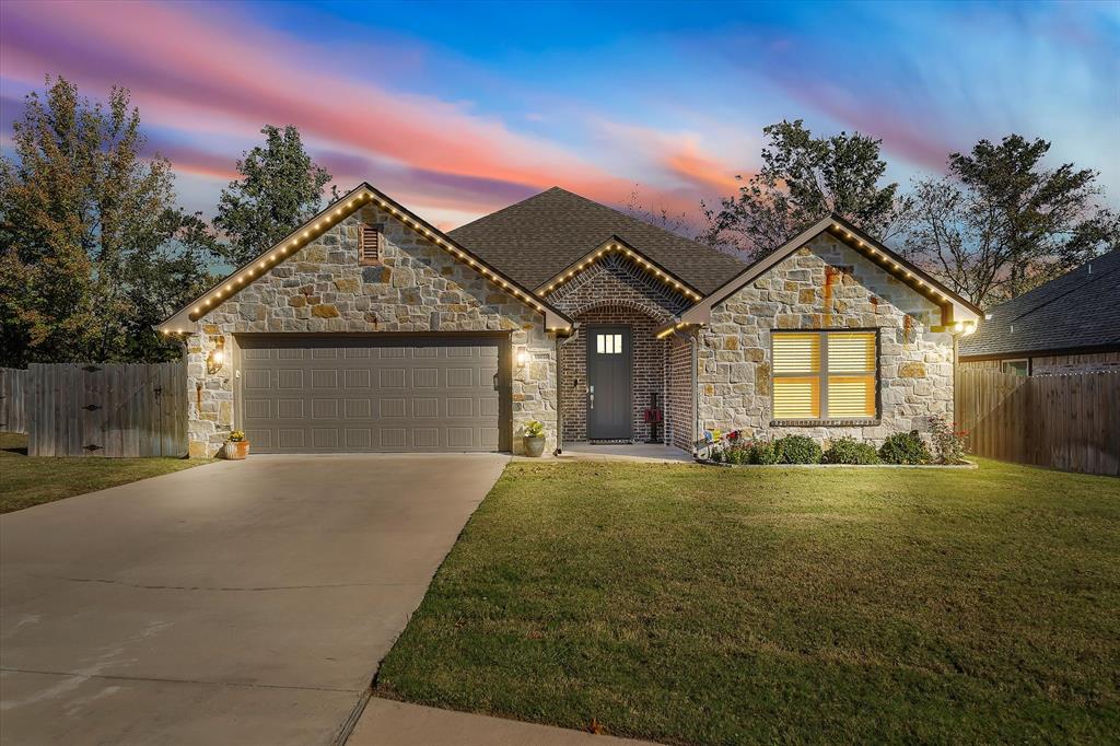 10059 Dayspring Drive Flint, TX 75762 - Photo 1 of 37 a front view of a house with a yard and garage