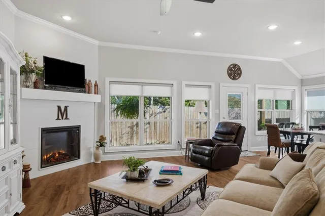 a living room with furniture a fireplace and a flat screen tv