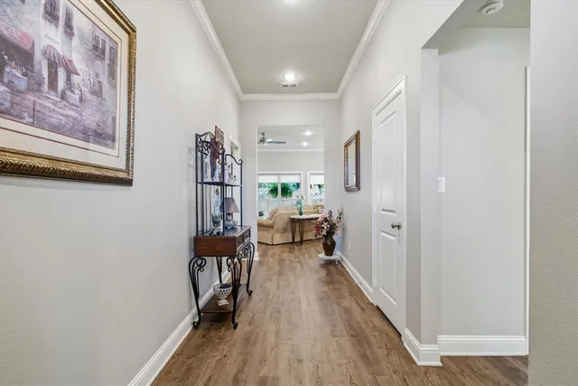 a view of a hallway and wooden floor